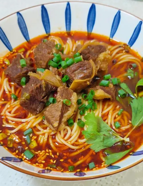 Taiwanese Beef Noodle Soup — rich red-braised beef broth with large chunks of tender beef and wide noodles